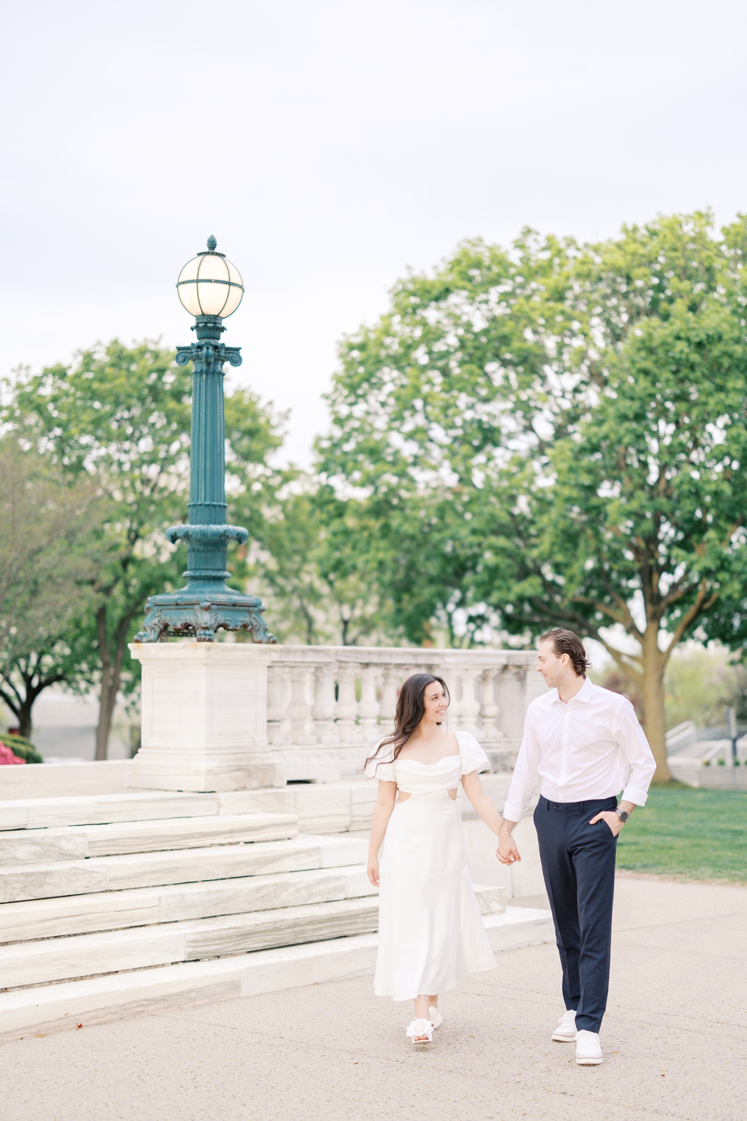 Engaged couple walking holding hands